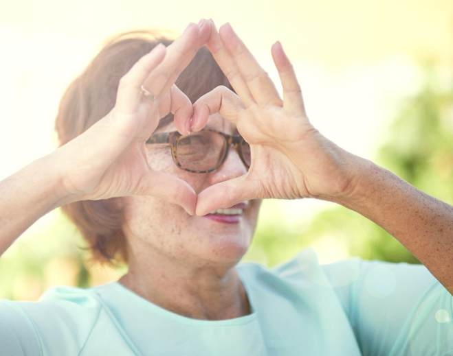 Person forming heart shape with hands