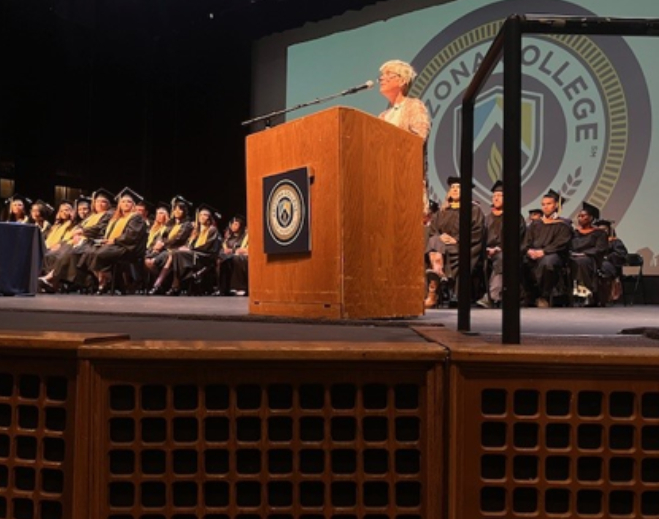 Person speaking at graduation ceremony podium