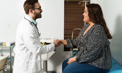 Doctor shaking hands with patient in clinic