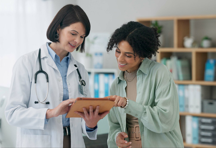 Doctor and patient reviewing information on tablet